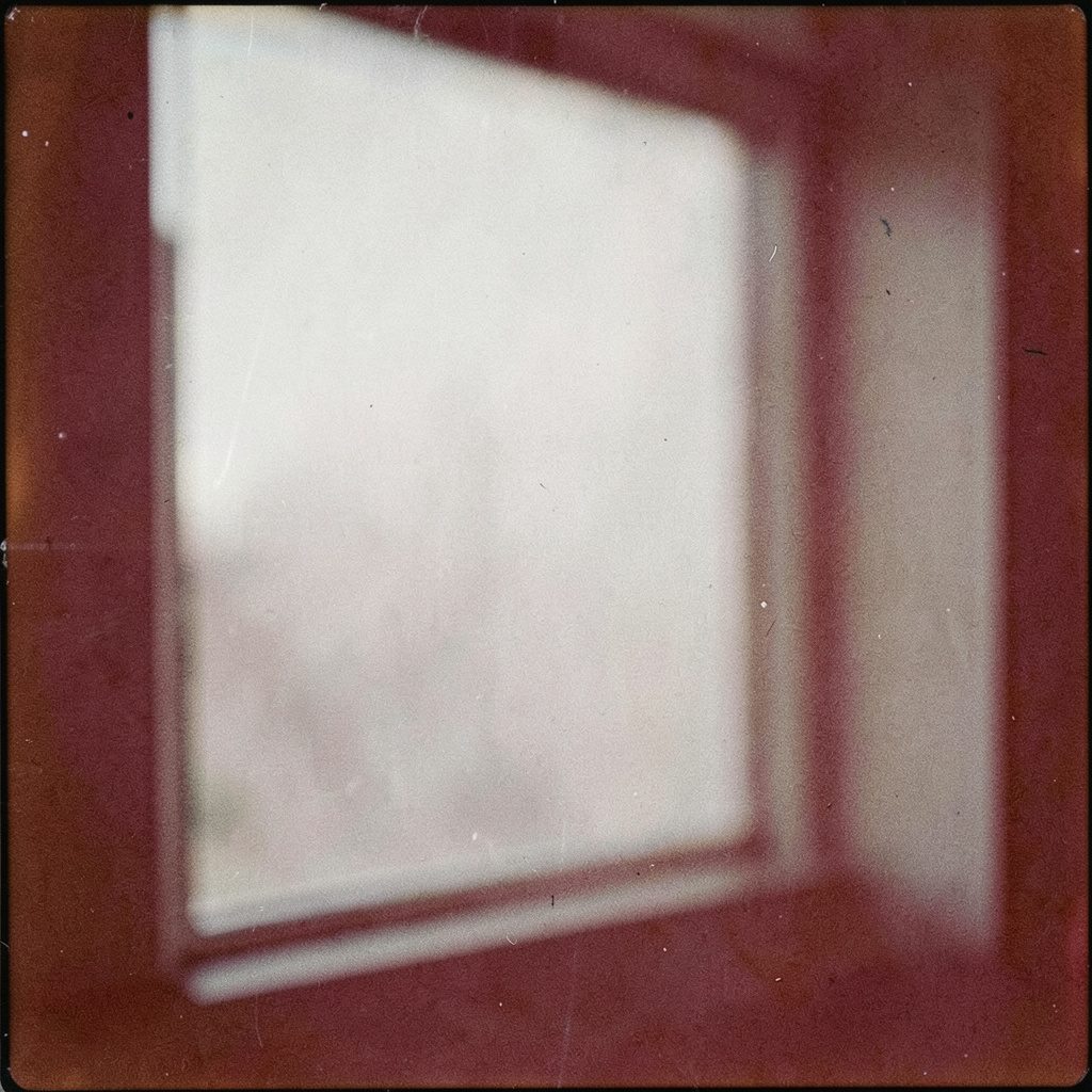 Vintage-toned photograph of a festival window display, sepia highlights and soft teal shadows, grainy texture.